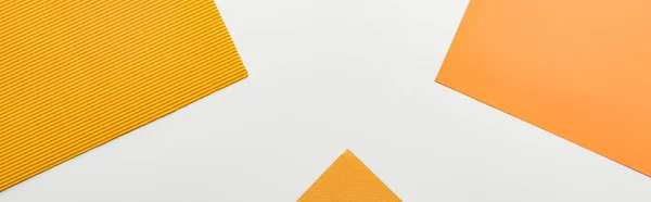 Panoramic shot of bright yellow paper on white background — Stock Photo