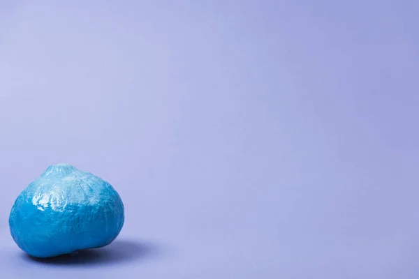 Painted blue pumpkin on violet background — Stock Photo