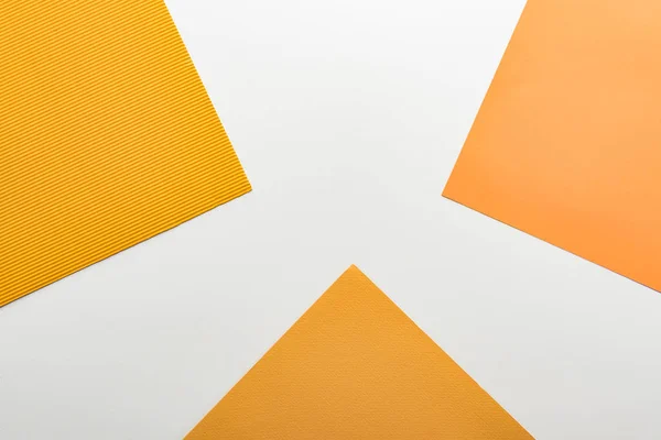 Top view of bright yellow paper on white background — Stock Photo