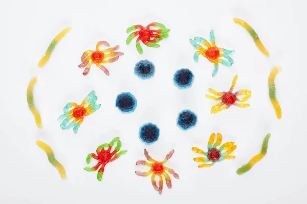 Top view of colorful gummy spiders and worms isolated on white, Halloween treat — Stock Photo