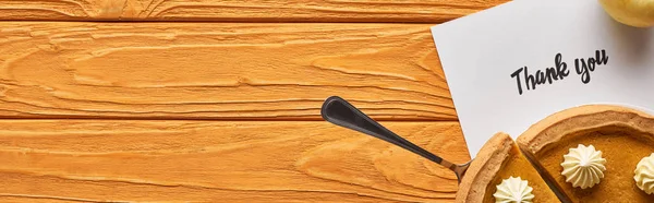 Top view of delicious pumpkin pie and thank you card on wooden orange table, panoramic shot — Stock Photo