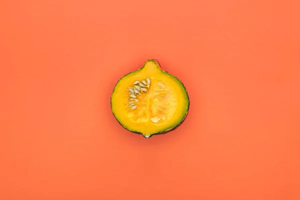 Top view of yellow cut pumpkin on orange background with copy space — Stock Photo