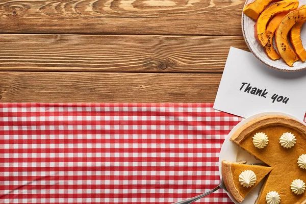 Top view of tasty pumpkin pie and thank you card on wooden rustic table with checkered napkin — Stock Photo