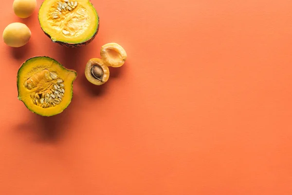 Vista superior de albaricoque amarillo y calabaza sobre fondo naranja con espacio para copiar - foto de stock