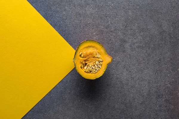 Top view of pumpkin on yellow and grey background — Stock Photo