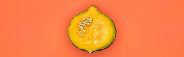 Top view of yellow cut pumpkin on orange background with copy space, panoramic shot — Stock Photo