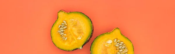 Top view of yellow cut pumpkin on orange background with copy space, panoramic shot — Stock Photo