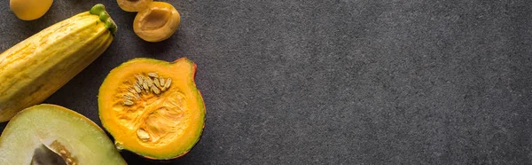 Top view of yellow fruits and vegetables on grey textured background with copy space, panoramic shot — Stock Photo