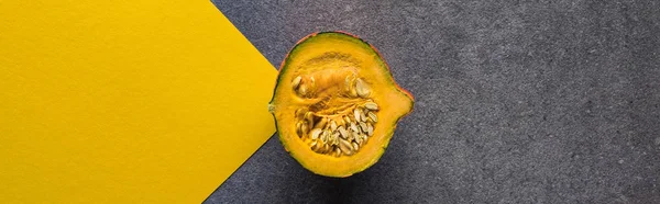 Top view of pumpkin on yellow and grey background, panoramic shot — Stock Photo