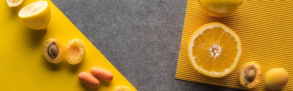 Top view of fruits and vegetables on yellow and grey background, panoramic shot — Stock Photo