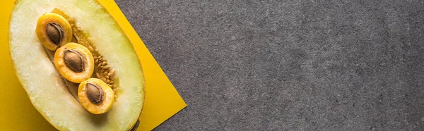 Top view of melon and apricots on yellow and grey background with copy space, panoramic shot — Stock Photo