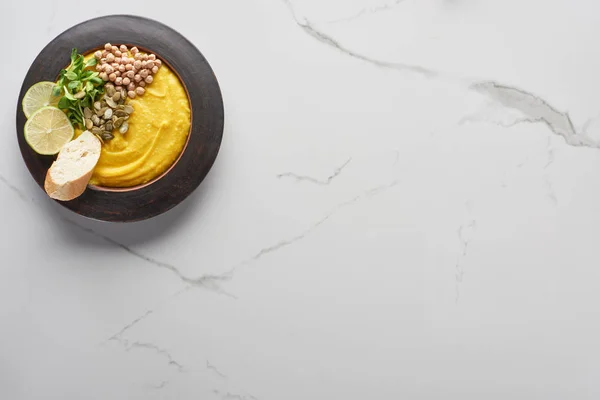 Top view of autumnal mashed pumpkin soup on marble table — Stock Photo