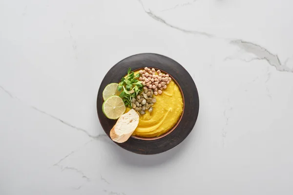 Top view of autumnal mashed pumpkin soup on marble table — Stock Photo