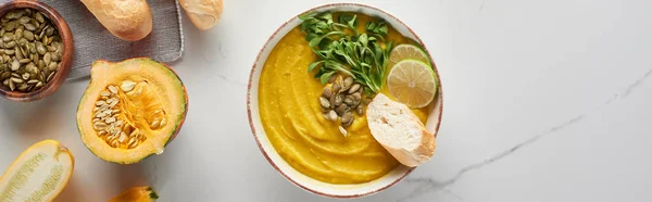 Top view of autumnal mashed pumpkin soup on marble table, panoramic shot — Stock Photo