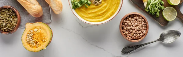 Top view of autumnal mashed pumpkin soup on marble surface, panoramic shot — Stock Photo