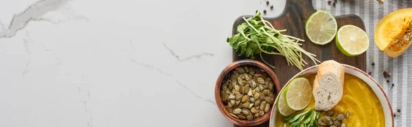 Vue de dessus de la soupe de citrouille en purée automnale sur planche à découper en bois, vue panoramique — Stock Photo