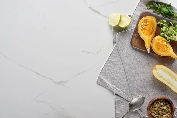 Vue de dessus de la citrouille, de la chaux, des courgettes et des germes sur la surface du marbre — Photo de stock