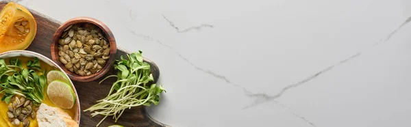 Панорамный снимок осеннего супа из тыквы на деревянной доске для резки мрамора с копировальным пространством — стоковое фото