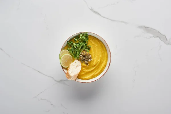 Top view of tasty mashed pumpkin soup on marble surface — Stock Photo
