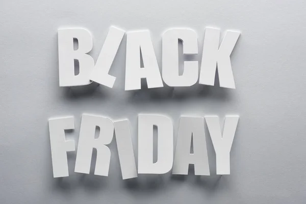 Top view of black Friday lettering on grey background — Stock Photo