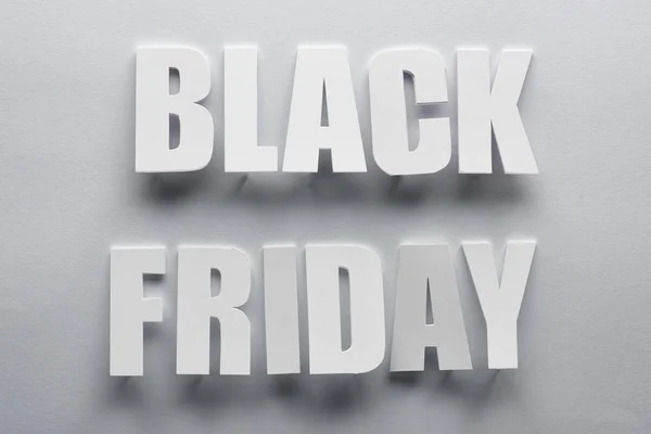 Top view of black Friday lettering on grey background — Stock Photo