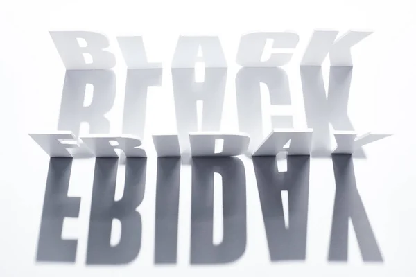 Vista superior de las letras del viernes negro con sombra sobre fondo blanco — Stock Photo