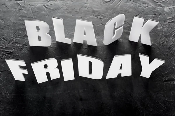 Top view of black Friday lettering on black background — Stock Photo