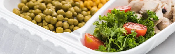 Panoramic shot of eco package with green peas, meat and salad on white background — Stock Photo