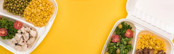 Panoramic shot of eco packages with vegetables, meat, fried eggs and salads isolated on yellow — Stock Photo