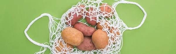 Top view of potato in eco friendly bag isolated on green — Stock Photo