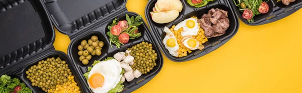 Panoramic shot of eco packages with apples, vegetables, meat, fried eggs and salads isolated on yellow — Stock Photo