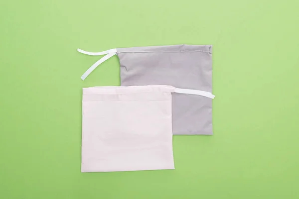 Top view of eco friendly bags isolated on green — Stock Photo