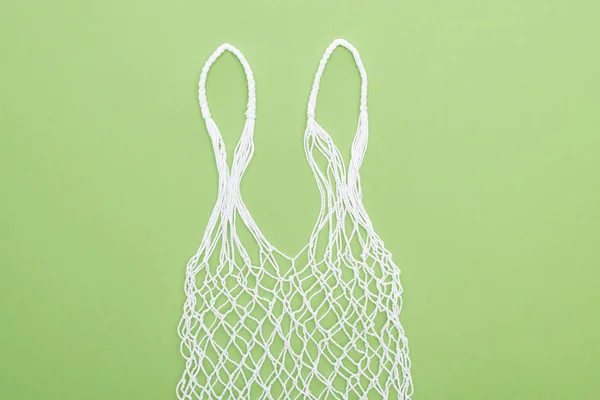 Top view of empty white string bag isolated on green — Stock Photo