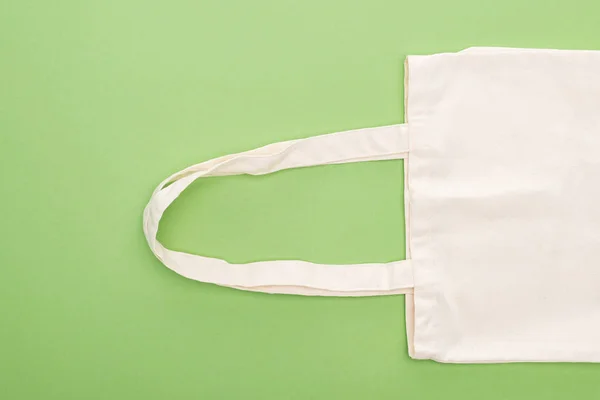 Top view of empty cotton eco bag isolated on green — Stock Photo