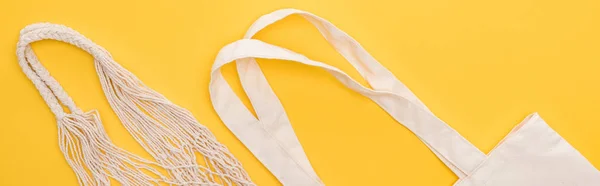 Top view of cotton eco friendly bags isolated on yellow, panoramic shot — Stock Photo