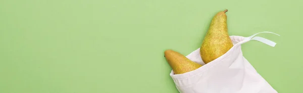 Top view of pears in eco friendly white bag isolated on green, panoramic shot — Stock Photo