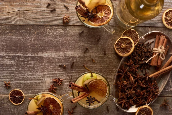 Top view of traditional pear mulled wine with spices on wooden rustic table — Stock Photo