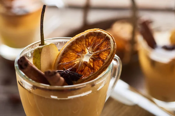 Close up view of seasonal traditional pear mulled wine with spices and dried citrus in glass — Stock Photo