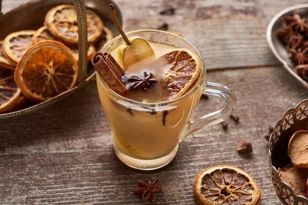 Seasonal traditional pear mulled wine with spices in glass on wooden rustic table — Stock Photo