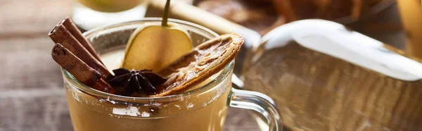 Close up view of tasty pear mulled wine with spices and dried citrus, panoramic shot — Stock Photo