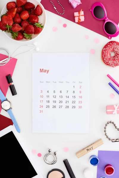 Mai-Kalenderblatt, frische Erdbeere, Sonnenbrille, digitales Tablet, Armbanduhr, Geschenkboxen, Kosmetik, Donut, Gouachefarbe, Holzblock mit Maibeschriftung isoliert auf weiß — Stockfoto