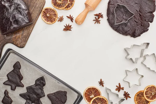 Top view of raw dough for chocolate Christmas cookies near ingredients on white background — Stock Photo