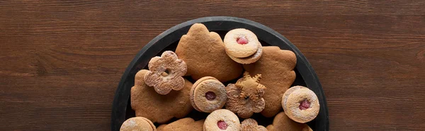 Top view of Christmas cookies in pan on wooden table, panoramic shot — Stock Photo