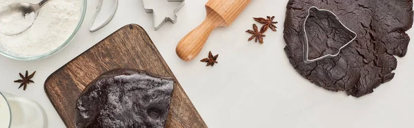 Top view of raw dough, anise, dough molds and rolling pin on white background, panoramic shot — Stock Photo