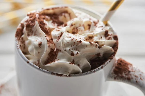 Close up view of Christmas cacao with cacao powder and whipped cream in mug with straw — Stock Photo