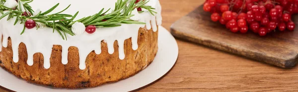 Christmas pie with rosemary and viburnum berries on wooden table — Stock Photo