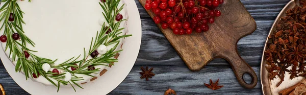 Top view of christmas pie, anise star seeds and viburnum berries on dark wooden table — Stock Photo