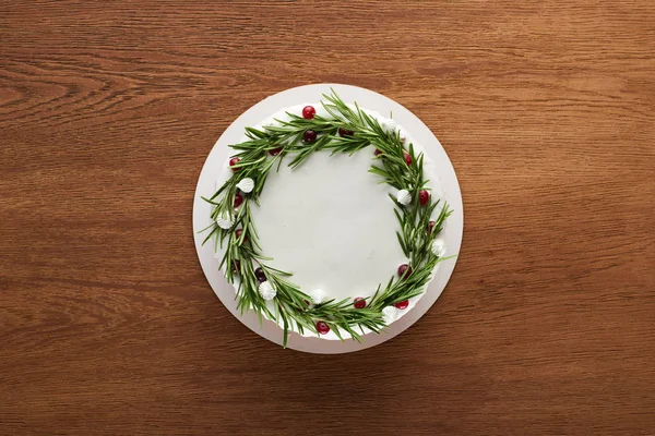 Top view of traditional christmas pie with rosemary and cranberries on wooden table — Stock Photo