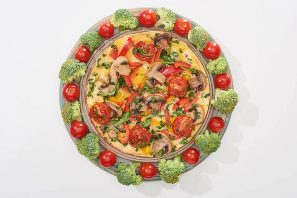 Вид сверху на домашний омлет на тарелке со свежими помидорами и брокколи — стоковое фото