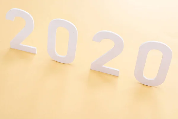 Paper white 2020 numbers on yellow background — Stock Photo